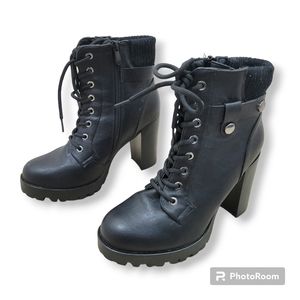 Chunky heel lace up faux leather combat boots.